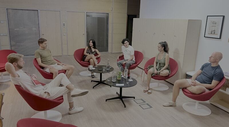 Six Speaker Circle participants seated in red chairs in a small practice and discussion circle.